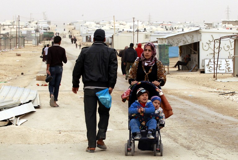 A Syrian refugee woman pushes a stroller at the Zaatari refugee camp, near the Jordanian border with Syria, on March 8, 2014. (photo credit: AFP/KHALIL MAZRAAWI) A Syrian refugee woman pushes a stroller at the Zaatari refugee camp, near the Jordanian border with Syria, on March 8, 2014. (photo credit: AFP/KHALIL MAZRAAWI)
