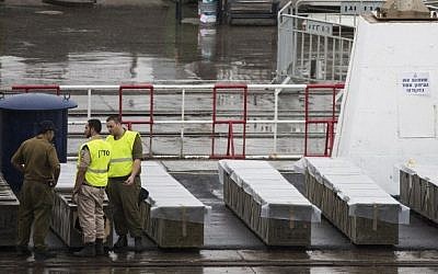 IDF troops inspect boxes of M-302 rockets that were unloaded from the Panamanian-flagged Klos-C vessel on March 9, 2014 at the southern Israeli port of Eilat. (photo credit: Jack Guez/AFP)