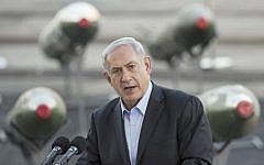 Prime Minister Benjamin Netanyahu speaks to the press at southern port of Eilat, Monday, March 10, 2014, as Israel displayed advanced M-302 rockets that were unloaded from the Panamanian-flagged Klos-C vessel (photo credit: AFP/ Jack Guez)