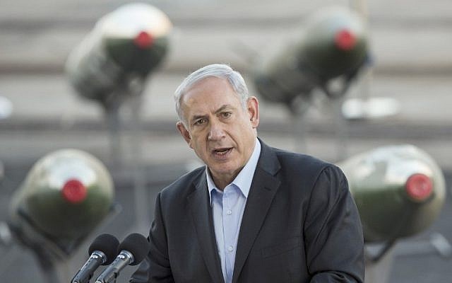 Prime Minister Benjamin Netanyahu at the port of Eilat, March 10, 2014, as Israel displayed intercepted advanced M-302 rockets that Iran attempted to smuggle to Israel's enemies (photo credit: AFP/ Jack Guez)