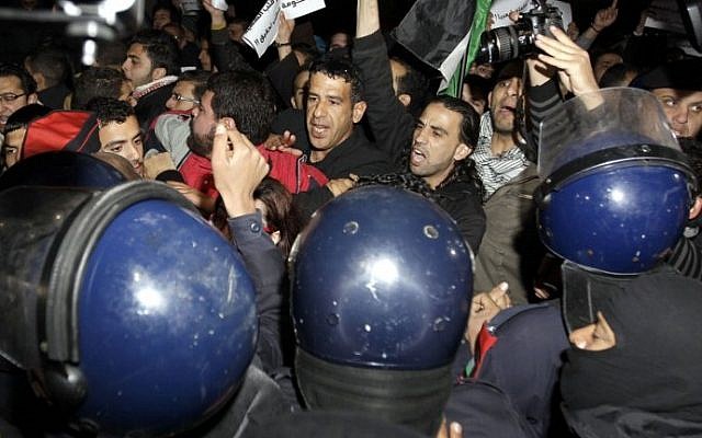 Riot police try to control several hundred angry Jordanians as they protest in front of the Israeli Embassy in Amman, Jordan, on Monday (photo credit: AFP/Khalil Mazraawi) Riot police try to control several hundred angry Jordanians as they protest in front of the Israeli Embassy in Amman, Jordan, on Monday (photo credit: AFP/Khalil Mazraawi)
