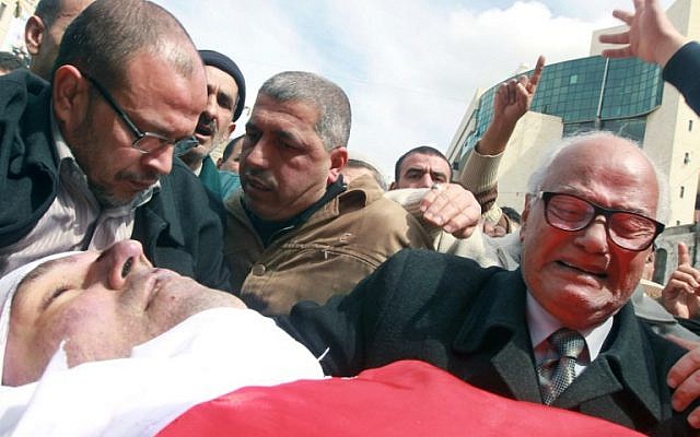 The father of Raed Zeiter grieves over his son's body during his funeral in the northern West Bank city of Nablus, on March 11, 2014 (photo credit: AFP/Jaafar Ashtiyeh) The father of Raed Zeiter grieves over his son's body during his funeral in the northern West Bank city of Nablus, on March 11, 2014 (photo credit: AFP/Jaafar Ashtiyeh)