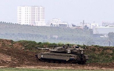 An Israeli army tank is seen stationed on the border between Israel and the Gaza Strip on March 13, 2014. (AFP/Jack Guez)