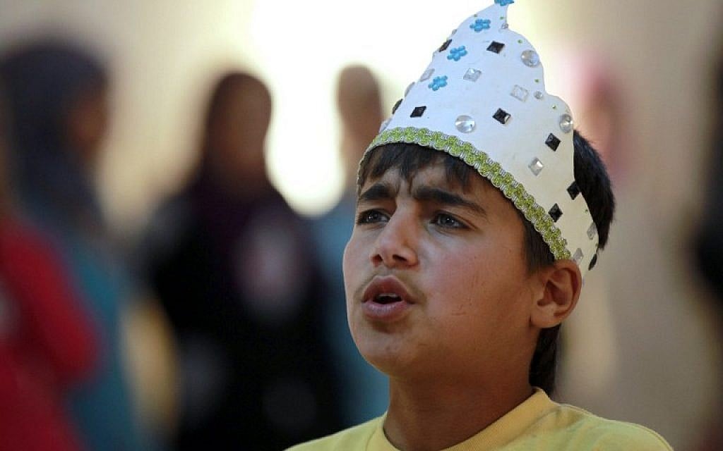 Syrian refugee Majd Ammari, 13, performs the role of King Lear during a rehearsal at the sprawling Zaatari refugee camp in the Jordanian desert near the border with Syria, March 8, 2014. (photo credit: AFP/Khalil Mazraawi) Syrian refugee Majd Ammari, 13, performs the role of King Lear during a rehearsal at the sprawling Zaatari refugee camp in the Jordanian desert near the border with Syria, March 8, 2014. (photo credit: AFP/Khalil Mazraawi)