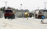 Trucks carrying fuel for the Gaza Strip enter Rafah through the Kerem Shalom crossing between Israel and the southern Gaza Strip on March 16, 2014. (AFP Photo/Said Khatib)