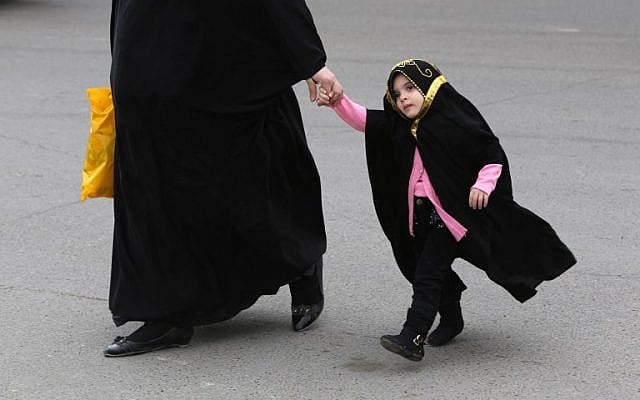 Illustrative: An Iraqi woman walks with her daughter in Baghdad on March 18, 2014. (photo credit: AFP/AHMAD AL-RUBAYE) Illustrative: An Iraqi woman walks with her daughter in Baghdad on March 18, 2014. (photo credit: AFP/AHMAD AL-RUBAYE)