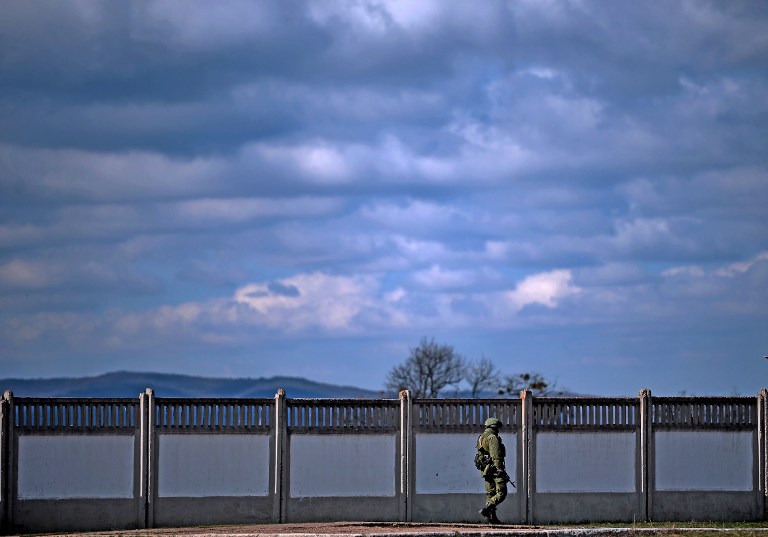 An armed man, believed to be a Russian serviceman, stands guard outside an Ukrainian military base in Perevalnoye on Thursday, March 13, 2014. (photo credit: AFP/Filippo Monteforte) An armed man, believed to be a Russian serviceman, stands guard outside an Ukrainian military base in Perevalnoye on Thursday, March 13, 2014. (photo credit: AFP/Filippo Monteforte)