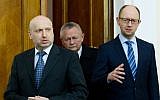 Ukrainian Prime Minister Arseniy Yatsenyuk (right), interim Ukrainian president Olexander Turchynov (left) and Defence Minister Igor Tenyukh (center) on March 18, 2014, in Kiev. (photo credit: AFP/UKRAINIAN PRESIDENTIAL PRESS SERVICE/MYKHAYLO MARKIV)