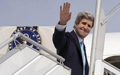 US Secretary of State John Kerry waves as he boards a plane in Paris, France, on March 31, 2014 (photo credit: AFP/pool/Jacquelyn Martin)