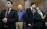 Former prime minister Ehud Olmert (C) waits in the Tel Aviv Destrict Court ahead of the reading of the verdict in the Holyland case, Monday, March 31, 2014 (photo credit: AFP/POOL/Dan Balilty)