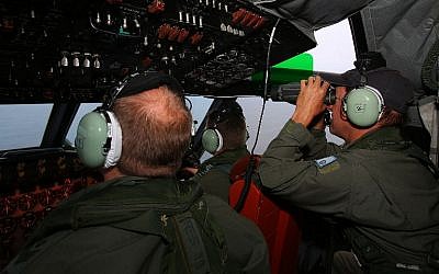 RAAF flight crew keep watch for debris from a AP-3C Orion during a search mission for missing Malaysia Airline flight MH370 in the Southern Indian Ocean on March 26, 2014.  (photo credit: AFP/ Paul KANE)