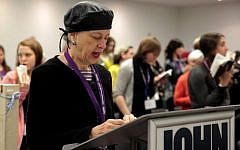 Illustrative: A woman leads a partnership minyan at a conference in New York of the Jewish Orthodox Feminist Alliance, December 2013. (Mike Kelly/JTA)