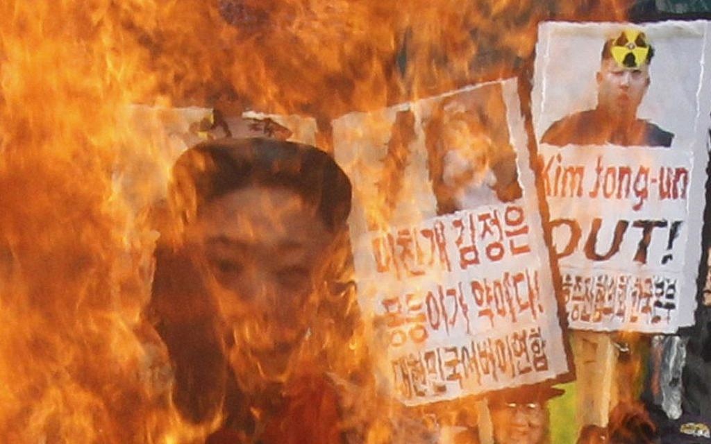 South Korean protesters burn an effigy of North Korean leader Kim Jong Un during an anti-North Korea rally to denounce North Korea's nuclear test in February 2013.  (photo credit:AP Photo/Ahn Young-joon, File)