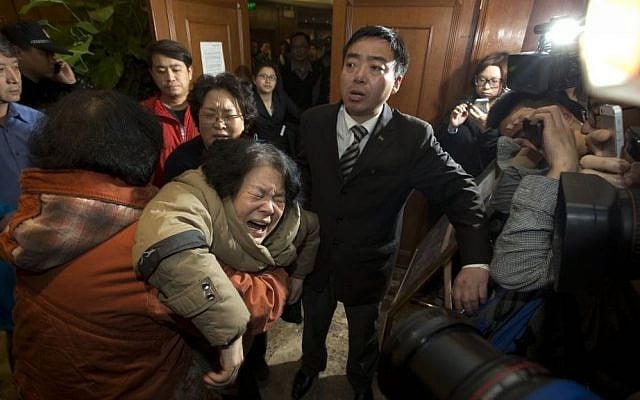 A relative of one of the Chinese passengers aboard Malaysia Airlines flight MH370 collapses in grief in Beijing, China, after being told that satellite data indicates the plane crashed into the Indian Ocean, Monday, March 24, 2014. (photo credit: AP/Ng Han Guan) A relative of one of the Chinese passengers aboard Malaysia Airlines flight MH370 collapses in grief in Beijing, China, after being told that satellite data indicates the plane crashed into the Indian Ocean, Monday, March 24, 2014. (photo credit: AP/Ng Han Guan)