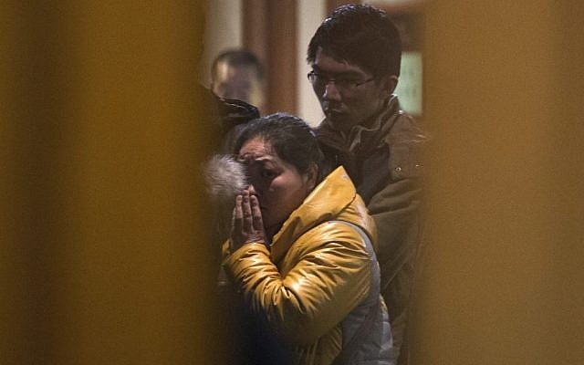 A Chinese relative of passengers aboard a missing Malaysia Airlines plane looks out from a hotel room for relatives or friends of passengers aboard the missing airplane, in Beijing, China Monday, March 10, 2014. (photo credit: AP Photo/Andy Wong) A Chinese relative of passengers aboard a missing Malaysia Airlines plane looks out from a hotel room for relatives or friends of passengers aboard the missing airplane, in Beijing, China Monday, March 10, 2014. (photo credit: AP Photo/Andy Wong)