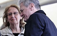 German President Joachim Gauck, right, passes Greek President's wife May Panou during a ceremony for dozens of villagers massacred by German army troops in 1943, in retaliation for the killing of a German officer by partisans, at the village of Ligiades in northwestern Greece, on Friday, March 7, 2014. (AP Photo/Thanassis Stavrakis)