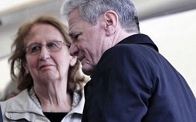 German President Joachim Gauck, right, passes Greek President's wife May Panou during a ceremony for dozens of villagers massacred by German army troops in 1943, in retaliation for the killing of a German officer by partisans, at the village of Ligiades in northwestern Greece, on Friday, March 7, 2014. (AP Photo/Thanassis Stavrakis)