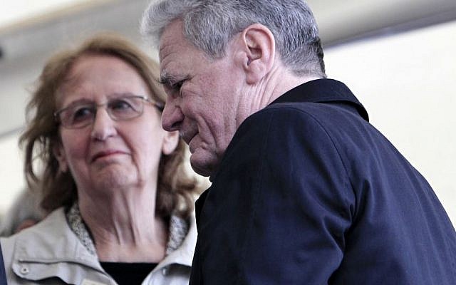 German President Joachim Gauck, right, passes Greek President's wife May Panou during a ceremony for dozens of villagers massacred by German army troops in 1943, in retaliation for the killing of a German officer by partisans, at the village of Ligiades in northwestern Greece, on Friday, March 7, 2014. (AP Photo/Thanassis Stavrakis) German President Joachim Gauck, right, passes Greek President's wife May Panou during a ceremony for dozens of villagers massacred by German army troops in 1943, in retaliation for the killing of a German officer by partisans, at the village of Ligiades in northwestern Greece, on Friday, March 7, 2014. (AP Photo/Thanassis Stavrakis)