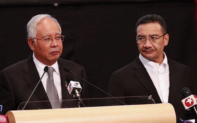 Malaysia's Prime Minister Najib Razak , left, and acting transport minister Hishammuddin Hussein speak during the press conference for the missing Malaysia Airlines jet, MH370, at Putra World Trade Centre  in Kuala Lumpur, Malaysia, Monday, March 24, 2014. (photo credit: AP/Vincent Thian)