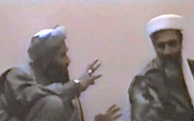 In this undated photo, Sulaiman Abu Ghaith, left, gestures toward al-Qaeda founder Osama Bin Laden, somewhere in Afghanistan (photo credit: AP/US Attorney’s Office for the Southern District of New York)