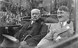 Paul von Hindenburg, left, and Adolf Hitler ride in an open car during a parade in Berlin, Germany, May 1933 (photo credit: unknown/German Federal Archive)
