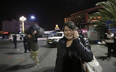 A woman reacts,at the crime scene outside a railway station after an attack, in Kunming, in southwestern China's Yunnan province, Saturday March 1, 2014. (photo credit: AP Photo) A woman reacts,at the crime scene outside a railway station after an attack, in Kunming, in southwestern China's Yunnan province, Saturday March 1, 2014. (photo credit: AP Photo)