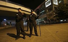 Policemen guard outside a railway station after an attack by knife wielding men left some 27 people dead in Kunming, in southwestern China's Yunnan province, Saturday March 1, 2014 (photo credit: AP)
