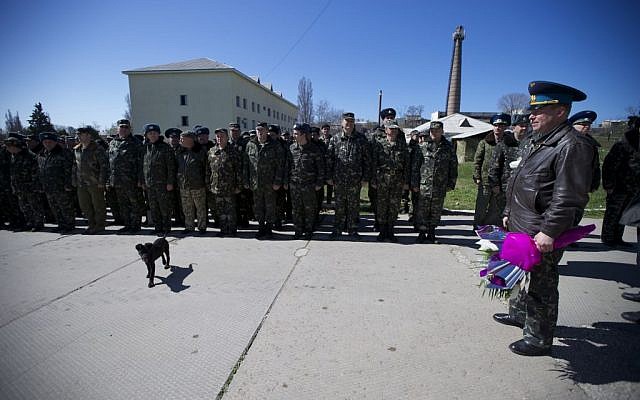 Colonel Yuly Mamchur, right, holds flowers as other Ukrainian airmen line up to greet their comrades who arrived to celebrate their wedding at the Belbek airbase outside Sevastopol, Crimea, on Saturday, March 22, 2014. (photo credit: AP Photo/Ivan Sekretarev) Colonel Yuly Mamchur, right, holds flowers as other Ukrainian airmen line up to greet their comrades who arrived to celebrate their wedding at the Belbek airbase outside Sevastopol, Crimea, on Saturday, March 22, 2014. (photo credit: AP Photo/Ivan Sekretarev)