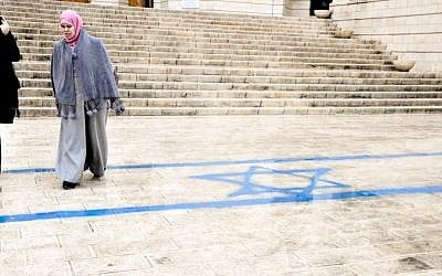 An Israeli flag was painted outside the courthouse. Walking over national or religious symbols is a sign of disrespect in Arab culture and in Muslim tradition, which requires the faithful to be barefoot when praying. (photo credit: Michal Shmulovich)