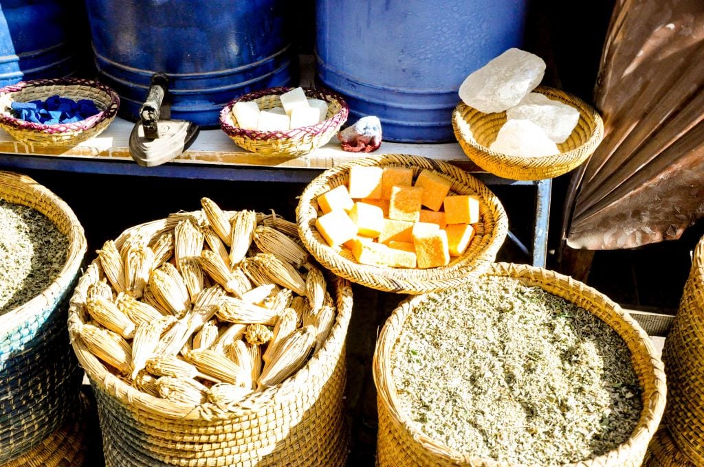 The mellah, or old Jewish quarter, in Marrakech is home to many silver stores and tiny herb and spice shops. This street vendor displayed, from left to right: natural toothbrushes; soft, amber resin that can be used as incense or perfume; and fresh Moroccan mint.