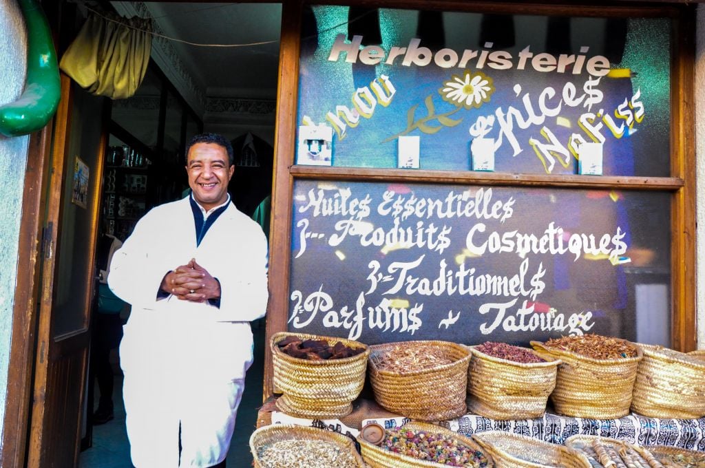 Herborist Ibnou Nafiss runs a natural remedy shop on the floor below the former synagogue. The rabbi of the synagogue used to live in the building, Nafiss said, and the family still owns the property. (photo credit: Michal Shmulovich)