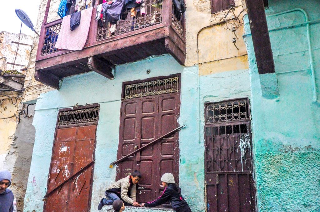 Boys play withd dice outside the Ibn Danan synagogue in Fez. (photo credit: Michal Shmulovich)