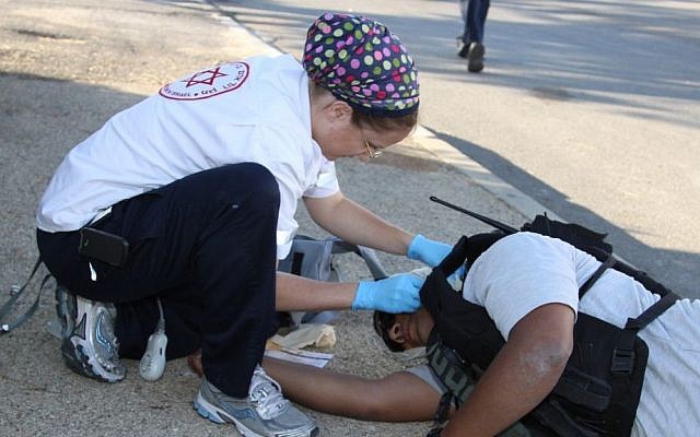 A Magen David Adom worker simulates treating a wounded Palestinian terrorist during a security drill in the settlement of Efrat, June 29, 2013 (photo credit: Flash90/Gershon Elinson) A Magen David Adom worker simulates treating a wounded Palestinian terrorist during a security drill in the settlement of Efrat, June 29, 2013 (photo credit: Flash90/Gershon Elinson)