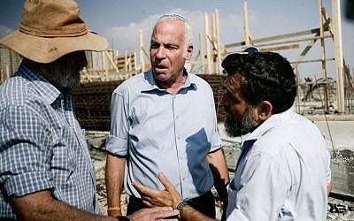 Housing and Construction Minister and Jewish Home parliament member Uri Ariel (C) with Yesha (Jewish settler organization) leader Ze'ev Chever (Zambish), head of the Amanah settlement organization, at a press conference promoting new housing units to be built in the Jewish settlement of Tel Tzion, near Jerusalem, on August 13, 2013 (photo credit: Flash90) Housing and Construction Minister Uri Ariel (C) at a press conference promoting new housing units to be built in the Jewish settlement of Tel Tzion, near Jerusalem, on August 13, 2013 (photo credit: Flash90)