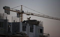Laborers work at a housing construction site in the  Har Homa neighborhood in southeast Jerusalem on October 27, 2013 (photo credit: Flash90)