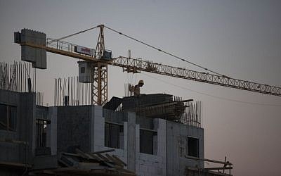 Labourers work at a housing construction site in the Israeli settlement of Har Homa in southeast Jerusalem on October 27, 2013 (photo credit: Flash90) Labourers work at a housing construction site in the Israeli settlement of Har Homa in southeast Jerusalem on October 27, 2013 (photo credit: Flash90)