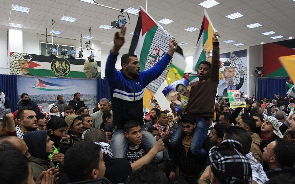 Palestinians celebrate the third installment of the prisoner release by Israel at the presidential compound in Ramallah, December 31, 2013. (photo credit: Issam Rimawi/Flash90)