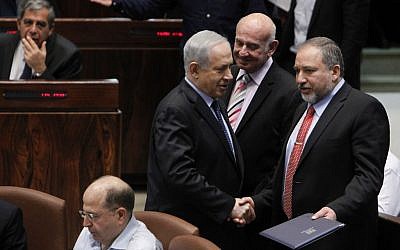 Foreign Minister Avigdor Liberman with Prime Minister Benjamin Netanyahu in the Knesset as it votes on the Governance Bill, March 11, 2014. (photo credit: Miriam Alster/FLASH90)