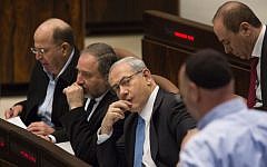 Defense Minister Moshe Ya'alon (L), Foreign Minister Avigdor Liberman (C) and Prime Minister Benjamin Netanyahu seen in the plenum hall during a vote on the Draft law. March 12, 2014. (Photo credit: Flash 90)