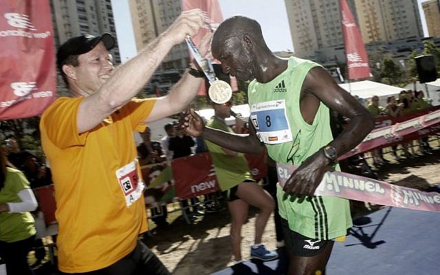 Jerusalem mayor Nir Barkat seen with the winner of the fourth international Jerusalem Marathon, Ronald Kimeli Kurgat, at the finish line on March 21, 2014. (Photo credit: Miriam Alster/ Flash90) Jerusalem mayor Nir Barkat seen with the winner of the fourth international Jerusalem Marathon, Ronald Kimeli Kurgat, at the finish line on March 21, 2014. (Photo credit: Miriam Alster/ Flash90)