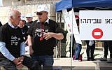 Foreign Ministry workers protest outside the ministry's offices in Jerusalem on March 24, 2014.  The sign reads 'Here there is a strike.' (Meital Cohen/Flash90)