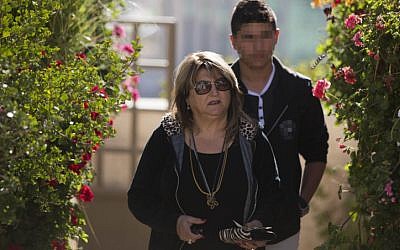 Shula Zaken, Ehud Olmert's bureau chief, leaves her home in Jerusalem on March 27, 2014. (photo credit: Yonatan Sindel/Flash90)