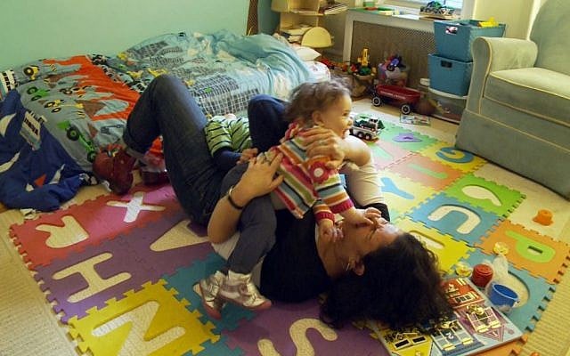 Rabbi Felicia Sol playing with her children. (Courtesy of Diva Communications, Inc.)