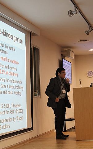 Asher Ornoy, of the Israeli Ministry of Health and the Hebrew University Hadassah Medical School, discusses services offered to Israeli children with autism at an Israel-Canada autism symposium held at Hebrew University's Edmond J. Safra Campus. (photo credit: Rebecca McKinsey/Times of Israel)