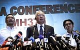 Malaysian Prime Minister Najib Razak, center, Malaysia's Minister for Transport Hishamuddin Hussein, left, and director general of the Malaysian Department of Civil Aviation, Azharuddin Abdul Rahman, speakto the media regarding the missing Malaysia Airlines jetliner MH370, Saturday, March 15, 2014. (photo credit: AP Photo/Wong Maye-E)