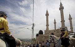 People ride horses near the new mosque, partially funded by Chechnya, in the Arab town of Abu Ghosh, near Jerusalem, March 23, 2014. (AP/Sebastian Scheiner)