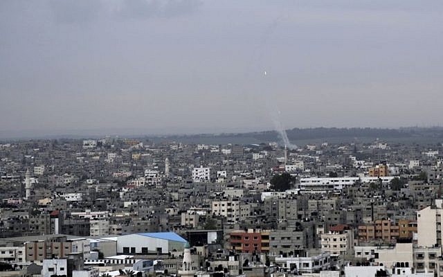 A trail of smoke from rockets fired by Palestinians from Gaza toward Israel is seen above Gaza City on Wednesday, March 12, 2014 (photo credit: AP/Adel Hana) A trail of smoke from rockets fired by Palestinians from Gaza toward Israel is seen above Gaza City on Wednesday, March 12, 2014 (photo credit: AP/Adel Hana)