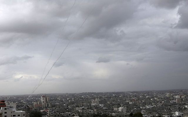A trail of smoke from rockets fired by Palestinians from Gaza toward Israel is seen above Gaza City on Wednesday, March 12, 2014. (photo credit: AP/Adel Hana) A trail of smoke from rockets fired by Palestinians from Gaza toward Israel is seen above Gaza City on Wednesday, March 12, 2014. (photo credit: AP/Adel Hana)