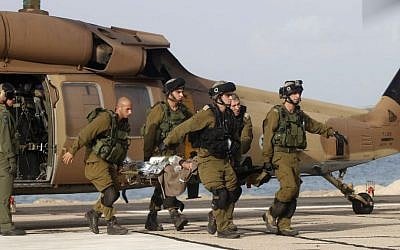 An Israeli soldier injured in a roadside bombing is brought to Rambam Hospital in Haifa on Tuesday (photo credit: AP/