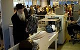 illustrative: Passengers have their hand luggage screened by security personnel at Ben-Gurion Airport, file photo (Ariel Schalit/AP)